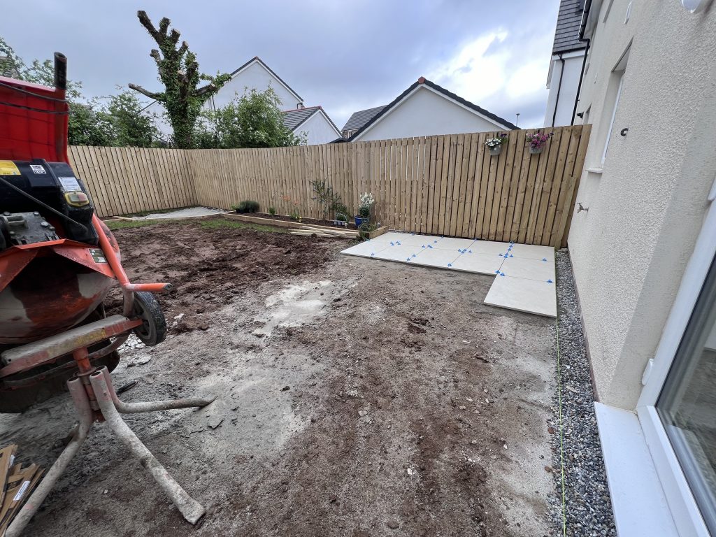a fenced backyard with a tractor and a fence