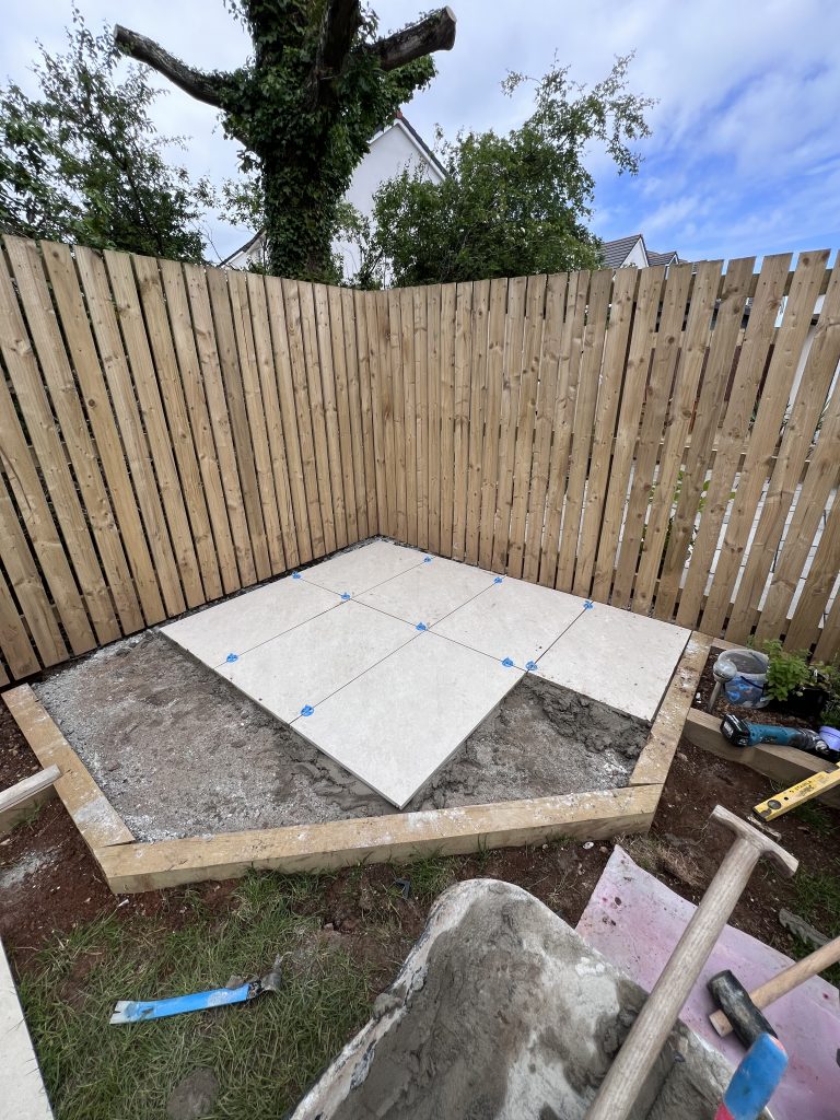 a backyard with a wood fence and a wood fence