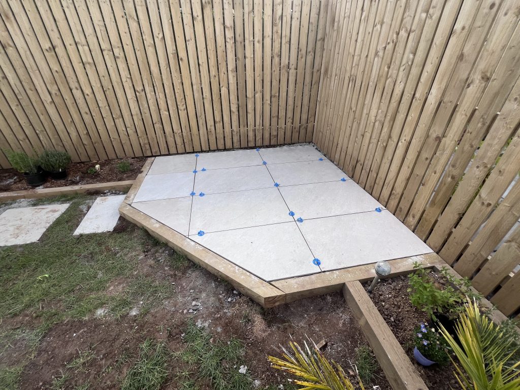 a patio with a wooden fence