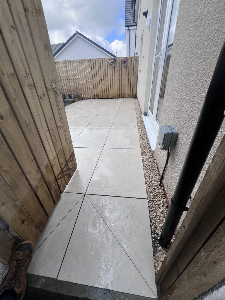 a patio with a fence and a wooden fence