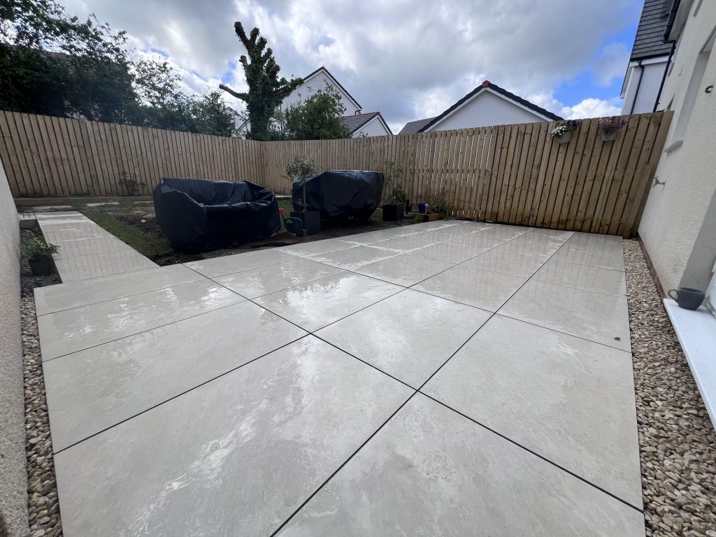 a patio with a fence and a wooden fence