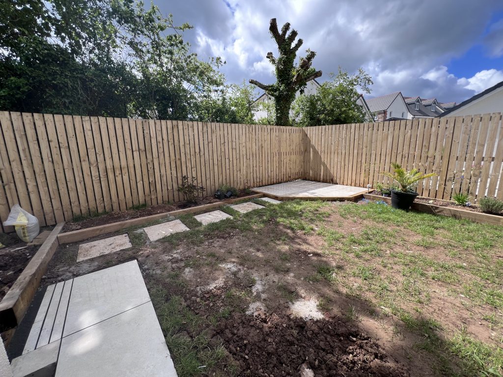 a backyard with a fence and a wooden fence