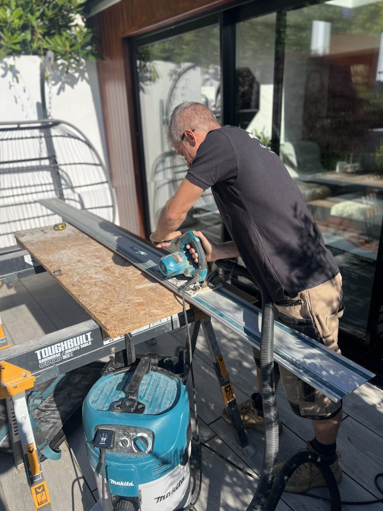 Ian Tubb working on cutting flooring
