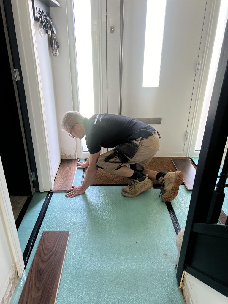 Ian Tubb laying first floor plank
