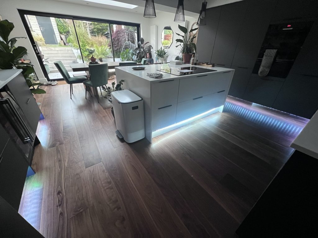 a kitchen with a wood floor and a wood floor