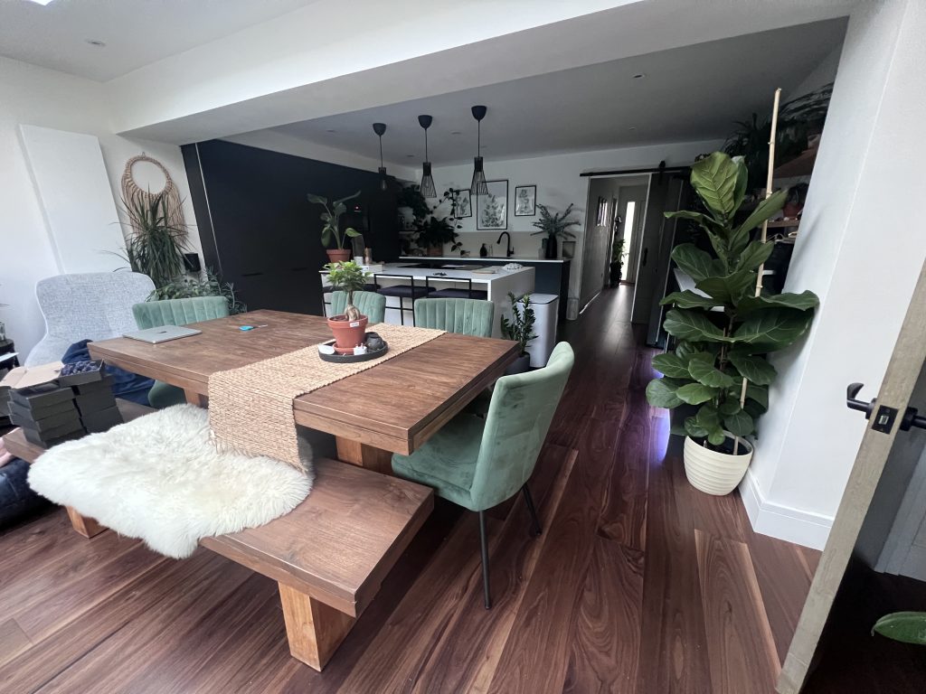 a dining table and chairs in a room with new laid floor